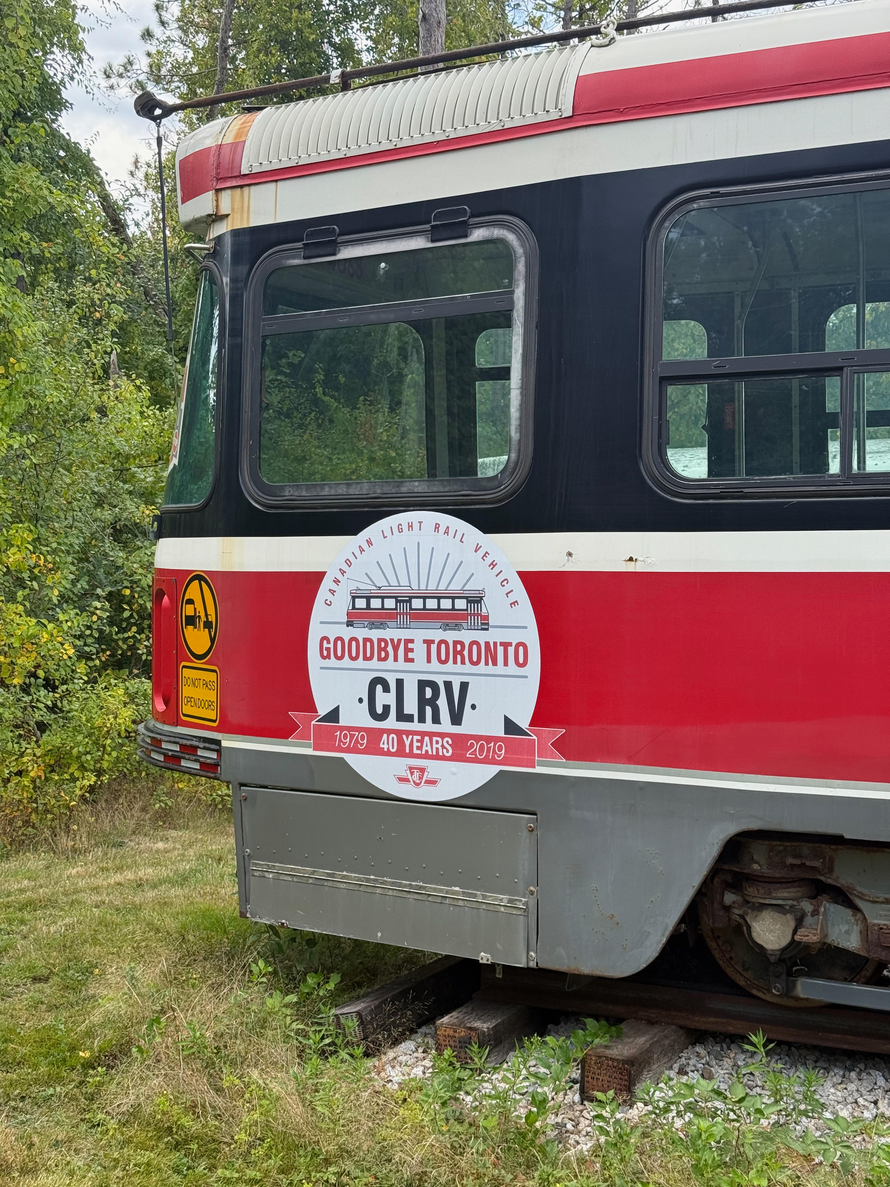 The side of a red and white Toronto streetcar featuring a commemorative white circular decal that reads “GOODBYE TORONTO CLRV, 1979->2019, 40 YEARS” with an illustration of the vehicle.